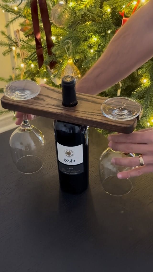Table Saw Projects: 15 Ideas to Build This Weekend 13 Wooden wine caddy holding a bottle and two glasses before a Christmas tree