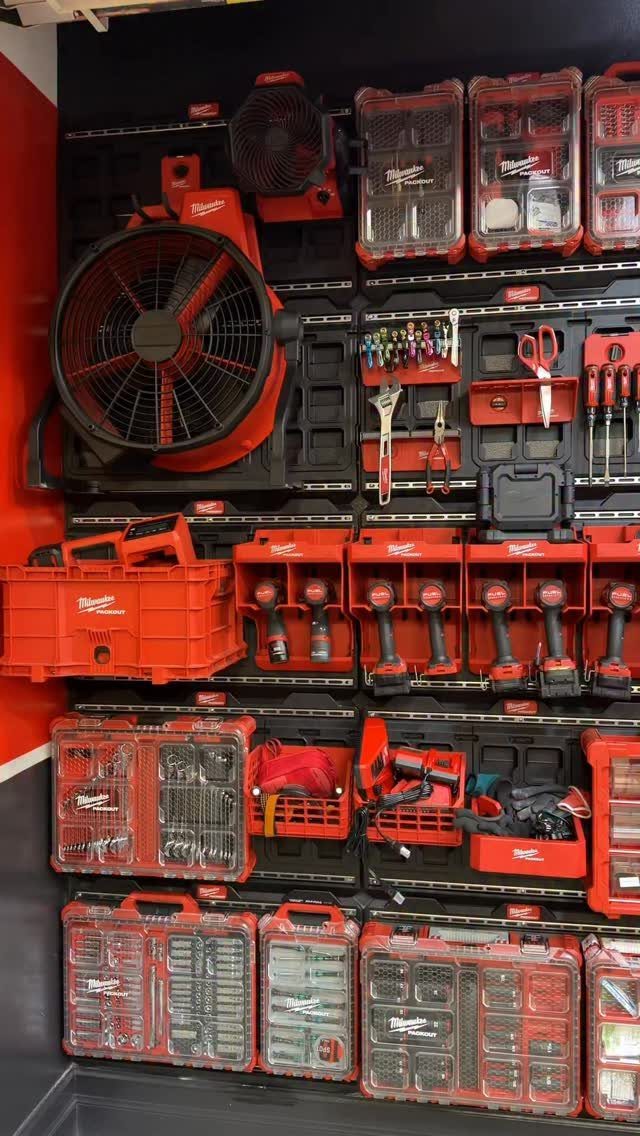 9 Tool Organization Wall Ideas for Garage and Shop 5 Red Milwaukee power tools and storage boxes organized on a black wall rack.