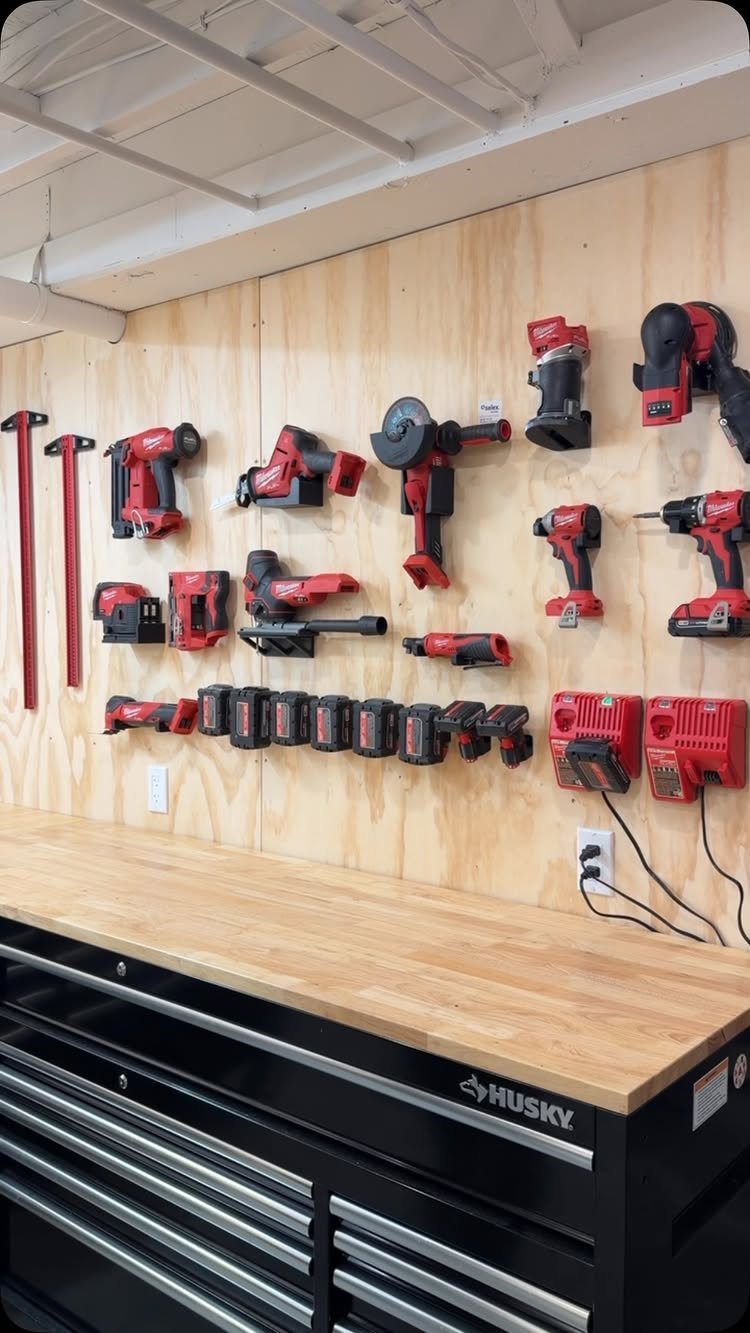 9 Tool Organization Wall Ideas for Garage and Shop 4 Red power tools organized on a plywood wall above a black tool chest.