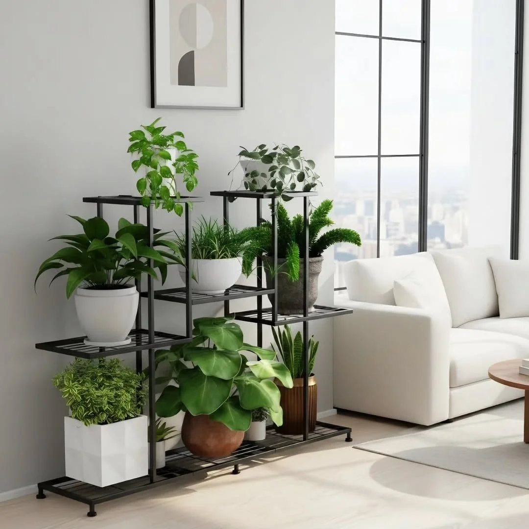 Black metal multi-tiered plant holder with various green potted plants in a living room
