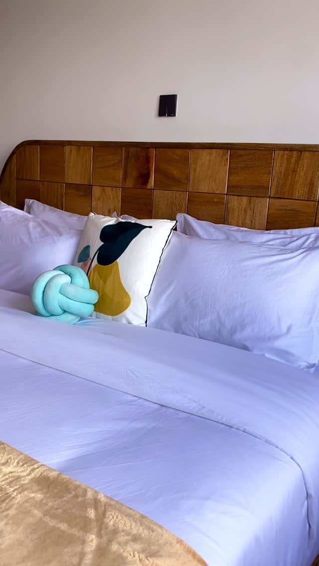 Wood Bed Design Ideas: 5 Styles for Every Bedroom 4 Wooden headboard with grid panels and white bedding with decorative pillows.