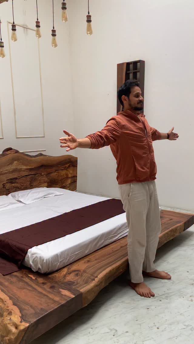 Wood Bed Design Ideas: 5 Styles for Every Bedroom 1 Live-edge wood bed frame with a matching headboard and a man standing beside it.