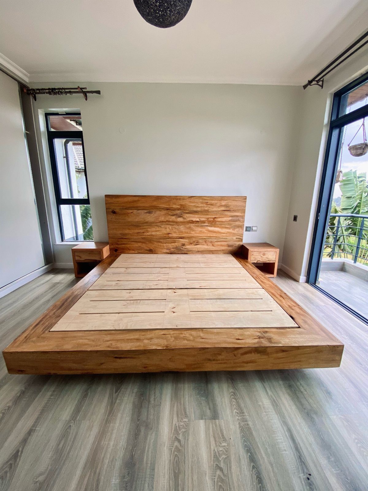 Wood Bed Design Ideas: 5 Styles for Every Bedroom 5 Low platform wood bed frame with matching headboard and nightstands in a bright bedroom