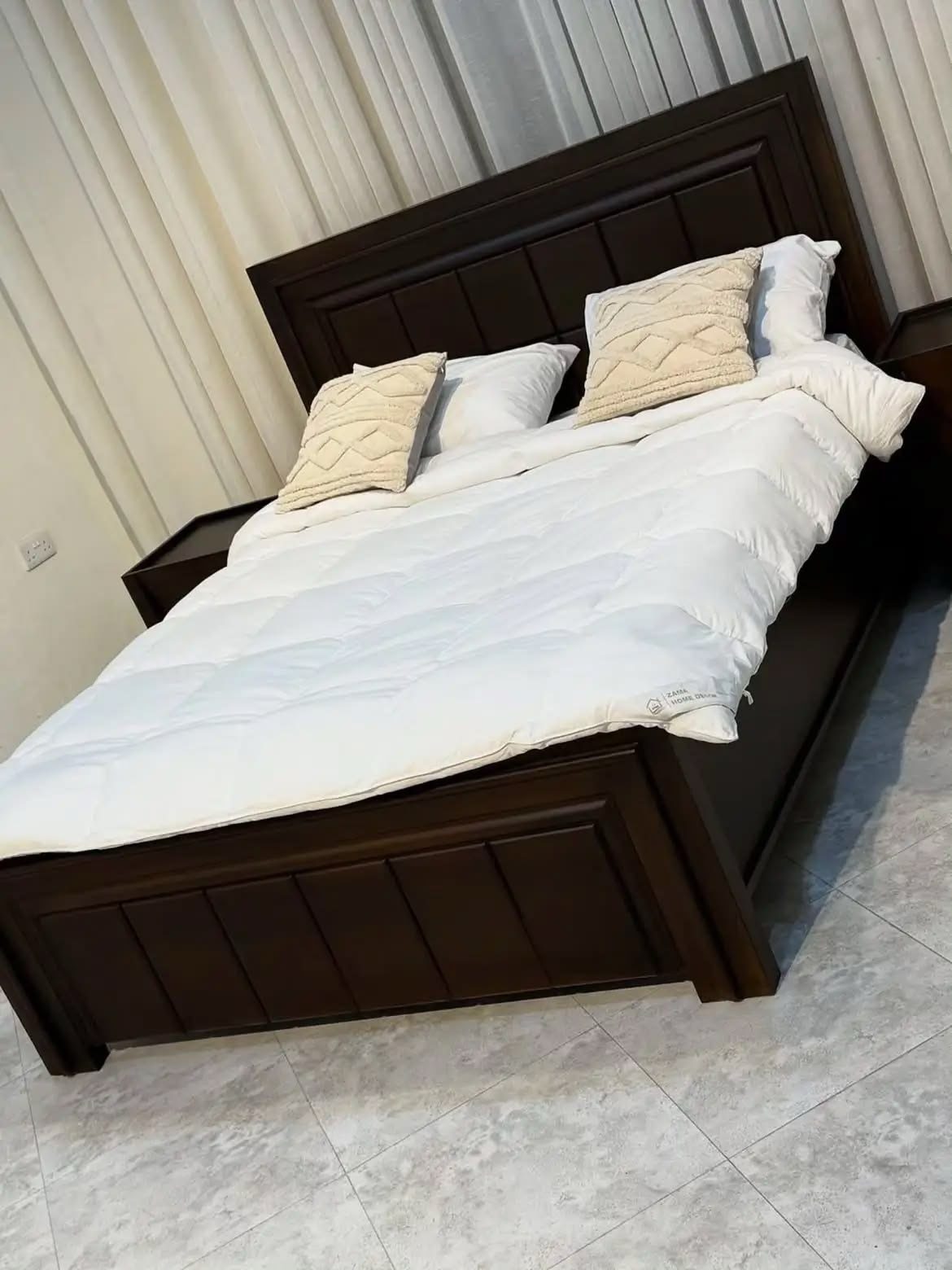 Wood Bed Design Ideas: 5 Styles for Every Bedroom 3 Dark brown wooden bed frame with white bedding and a paneled headboard.
