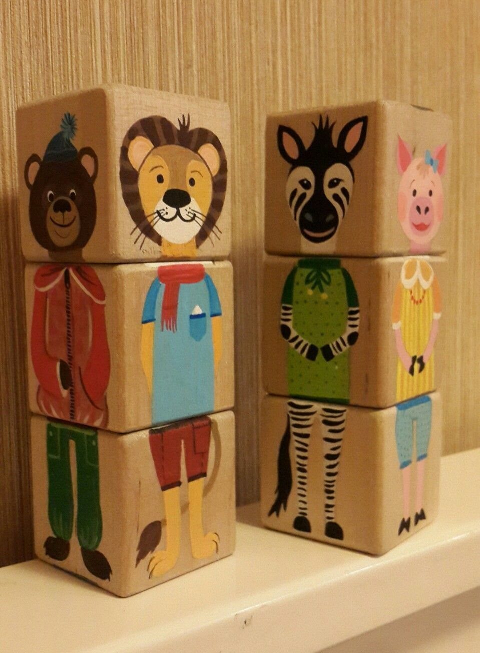14 Wood Block Decorations for Every Season and Room 11 Wooden blocks with painted animals including a bear, lion, zebra, and pig.