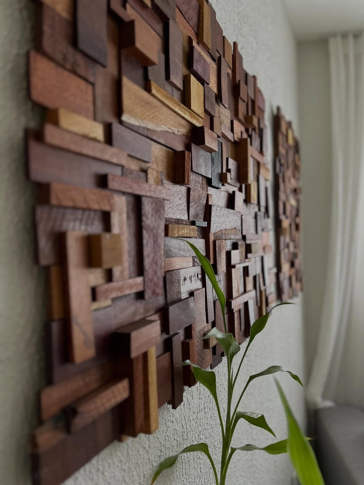 14 Wood Block Decorations for Every Season and Room 5 Abstract wall art composed of multi-dimensional brown wood blocks on a white wall.