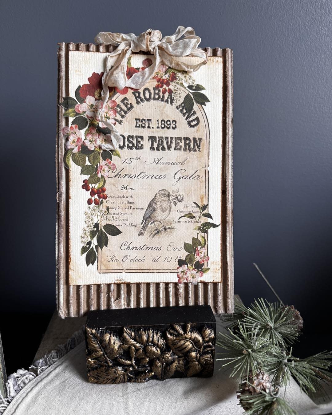 14 Wood Block Decorations for Every Season and Room 10 Vintage Christmas sign with floral accents and a carved wooden block on white cloth.