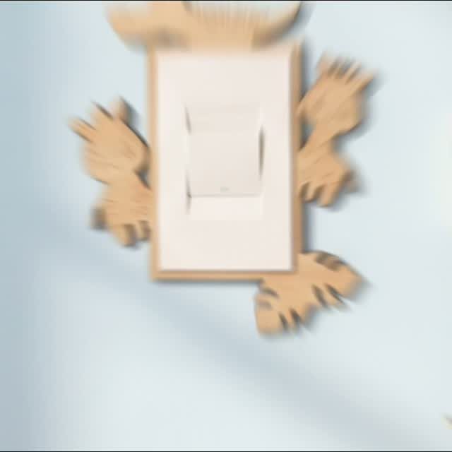 Decorative wooden light switch cover shaped like monster claws on a blue wall