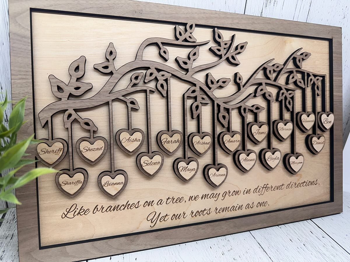 Wooden family tree wall art with heart-shaped name tags and an engraved quote.