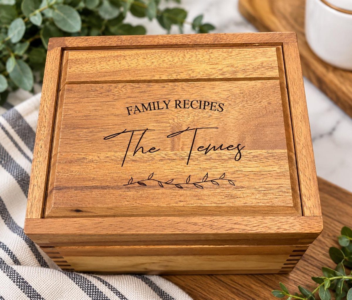 Personalized wooden recipe box with engraved family name and leaf design on lid
