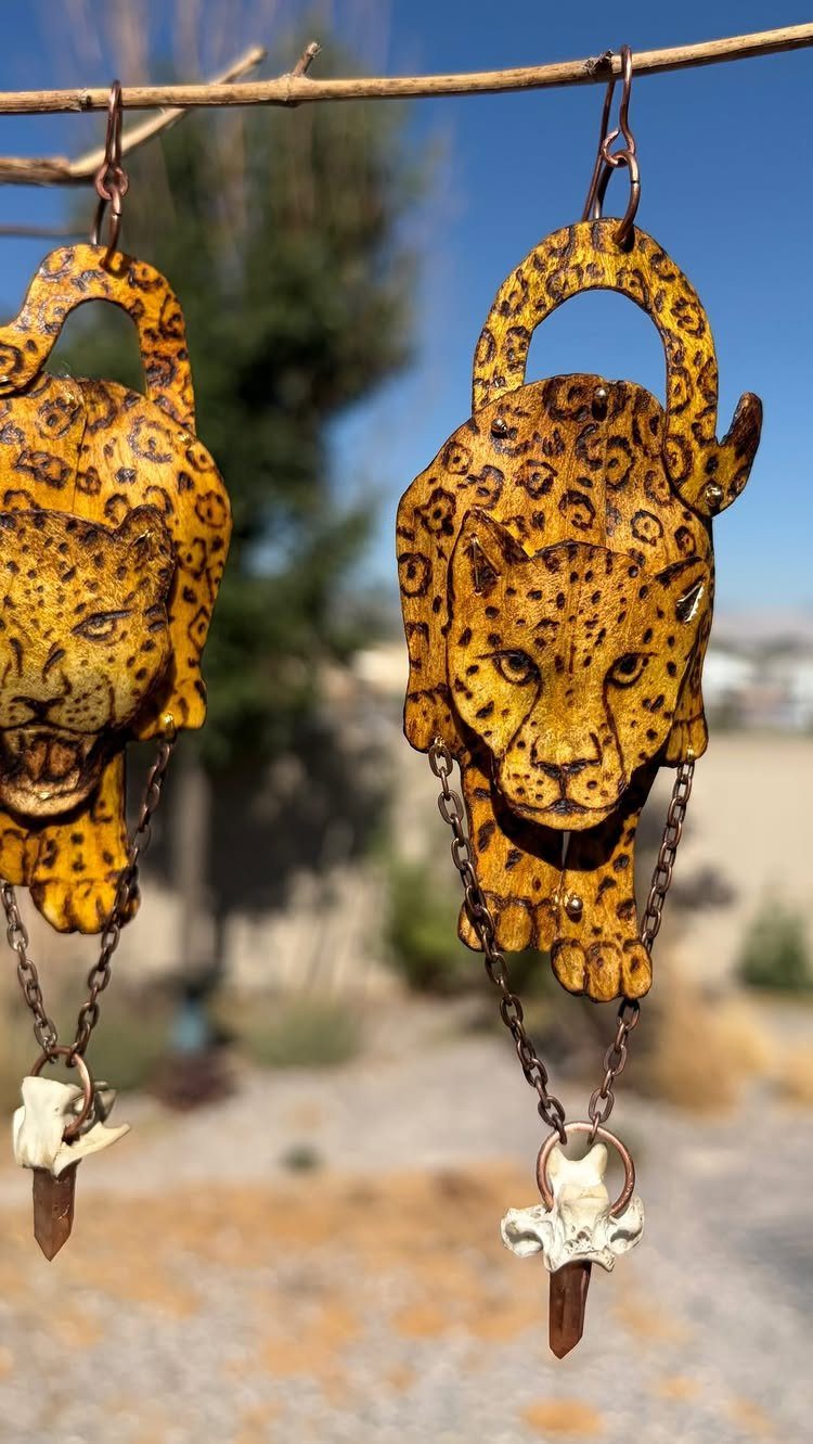 9 Wood Burning Images for Spoons, Plaques and Coasters 9 Wooden leopard earrings with pyrography details hanging from a natural tree branch.