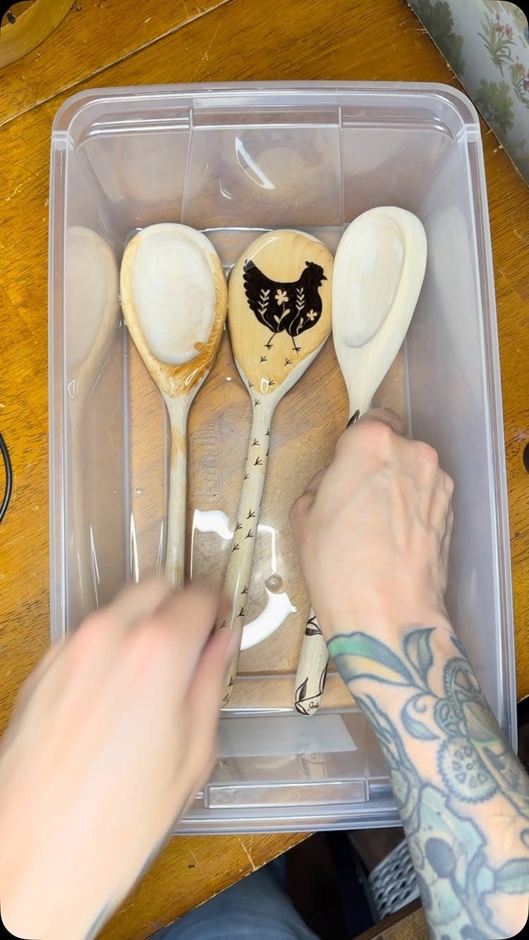 9 Wood Burning Images for Spoons, Plaques and Coasters 1 Wooden spoons in a plastic bin, one featuring a burned chicken design.