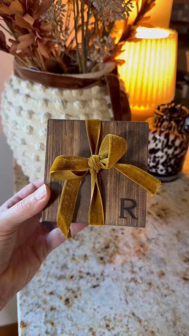 Wood Burning Ornaments: 8 Ideas for Christmas 1 Square wooden ornament with a burned letter R and gold velvet bow.