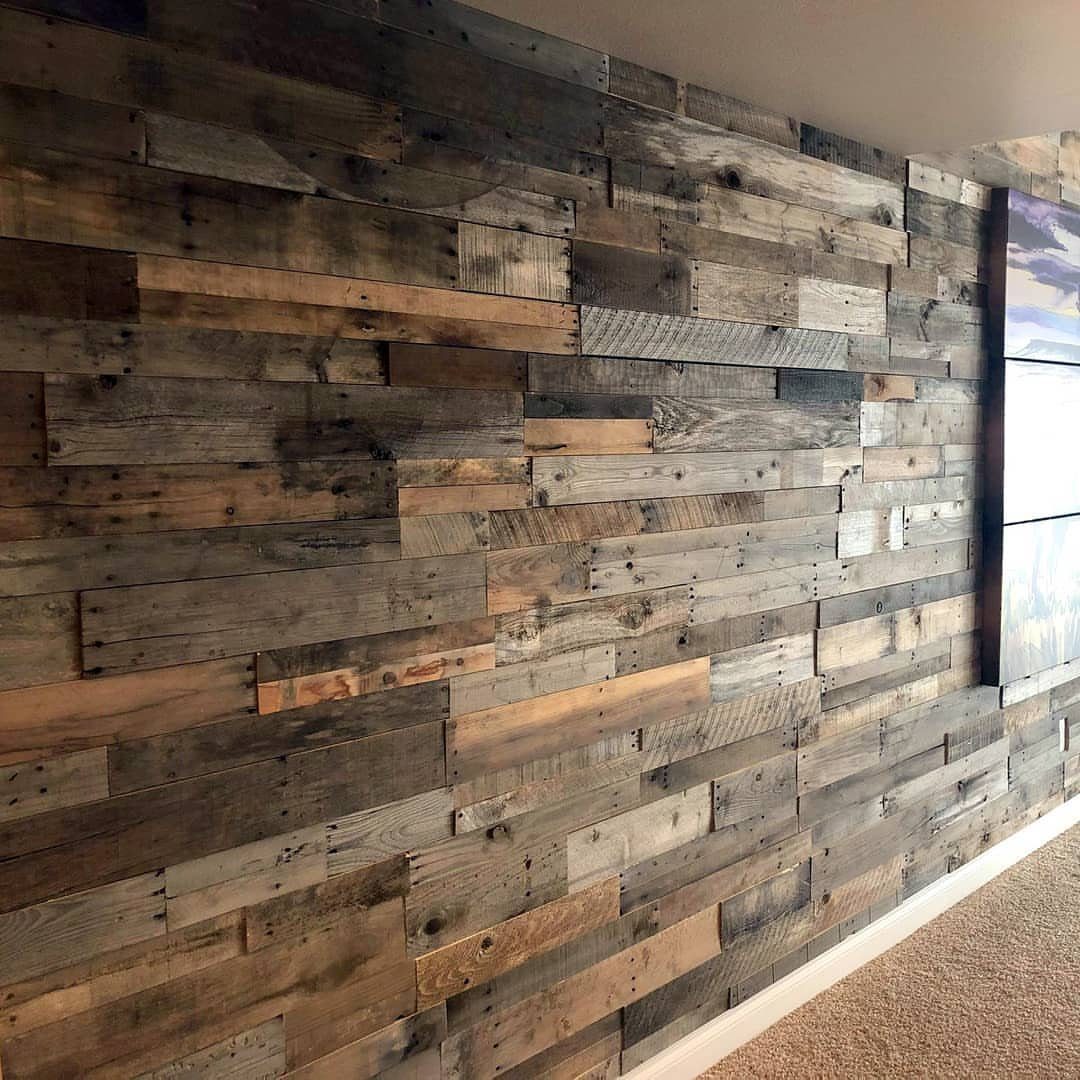 Reclaimed wood planks arranged in a staggered pattern on an interior wall.