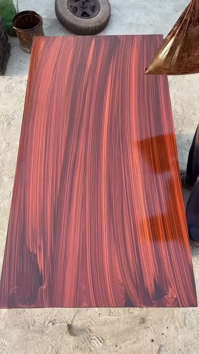 Glossy wooden tabletop with deep reddish-brown and dark brown swirling grain patterns.