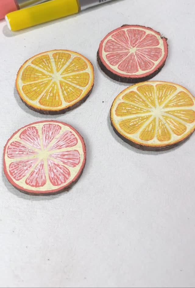 10 Wood Slice Crafts for Home Decor, Gifts and Games 6 Four wood slice coasters painted as yellow and pink citrus fruit slices.