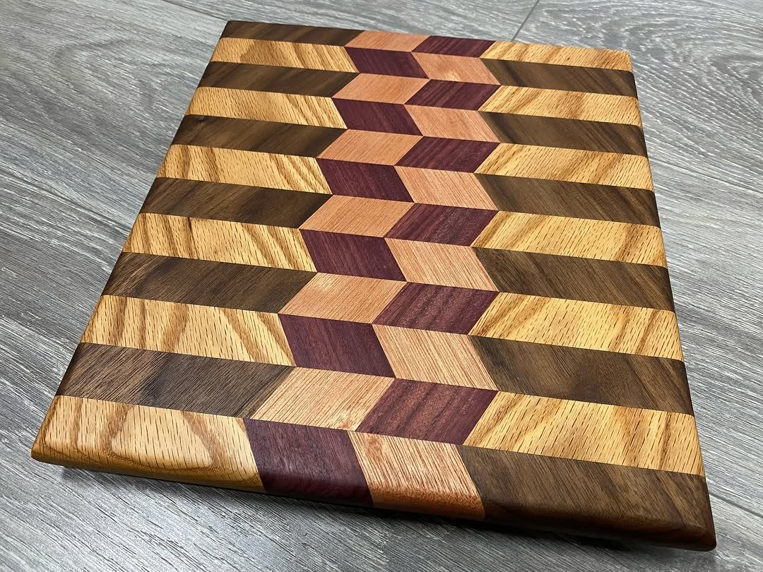 Wooden cutting board with a 3D geometric pattern in various brown tones.