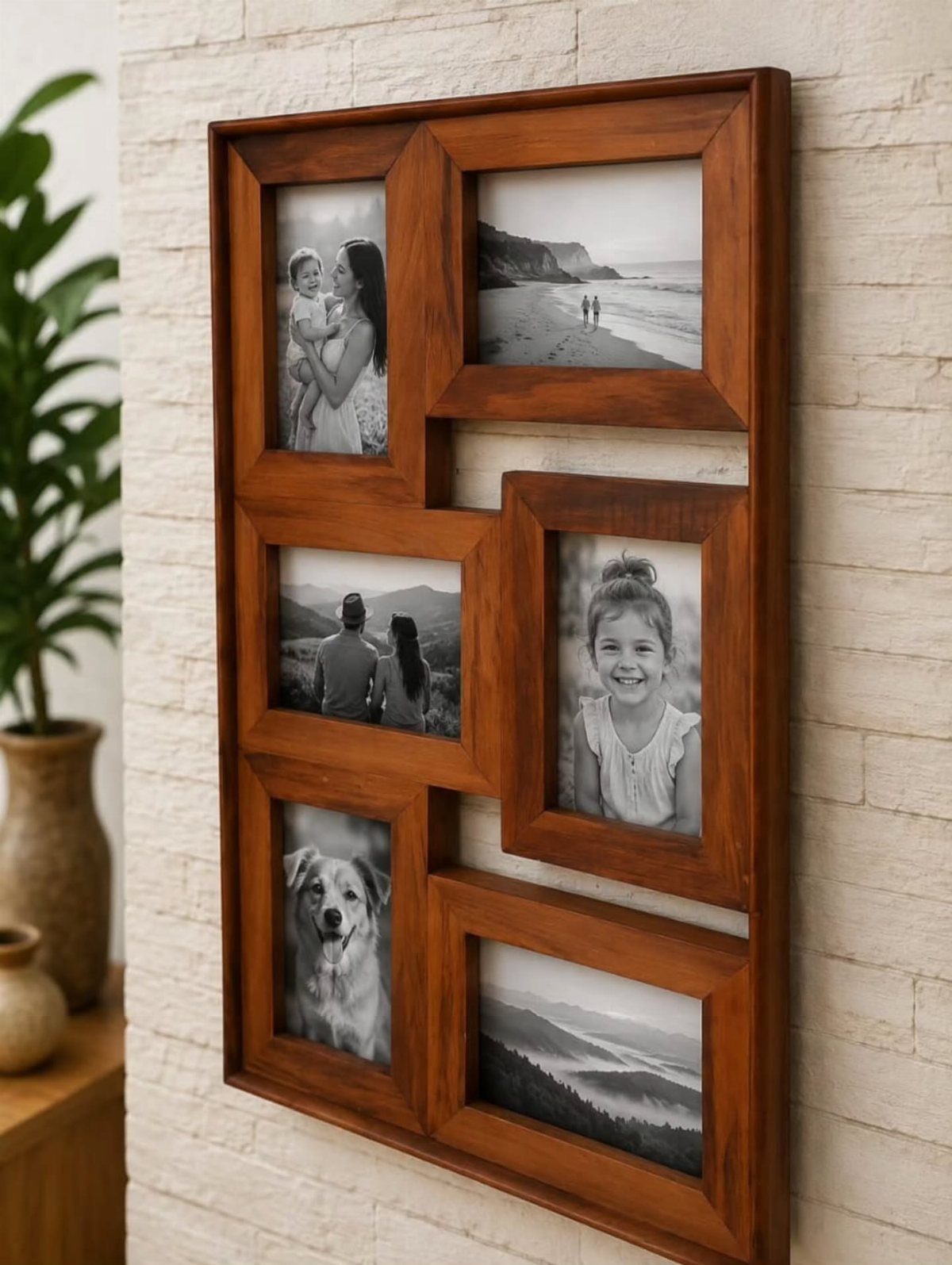 Brown wooden multi-photo frame with black and white pictures on a white brick wall