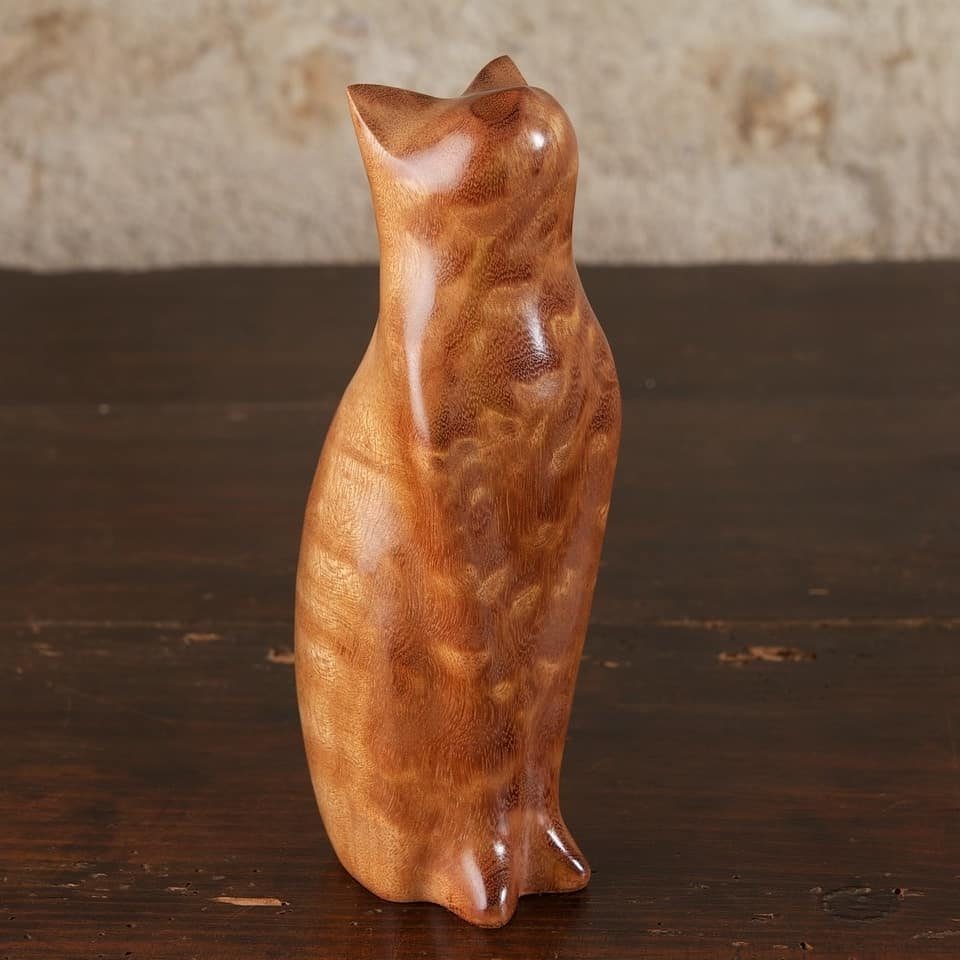 Wood Turned Cat Ideas: 5 Designs for the Lathe 1 Polished wooden cat figurine with smooth curves standing on a dark wood table.
