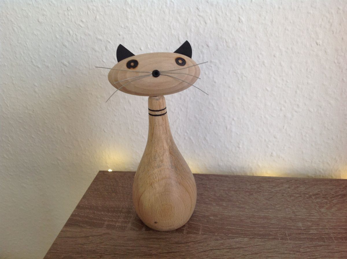 Wood Turned Cat Ideas: 5 Designs for the Lathe 3 Wooden cat figurine with wire whiskers and black ears on a wooden shelf.