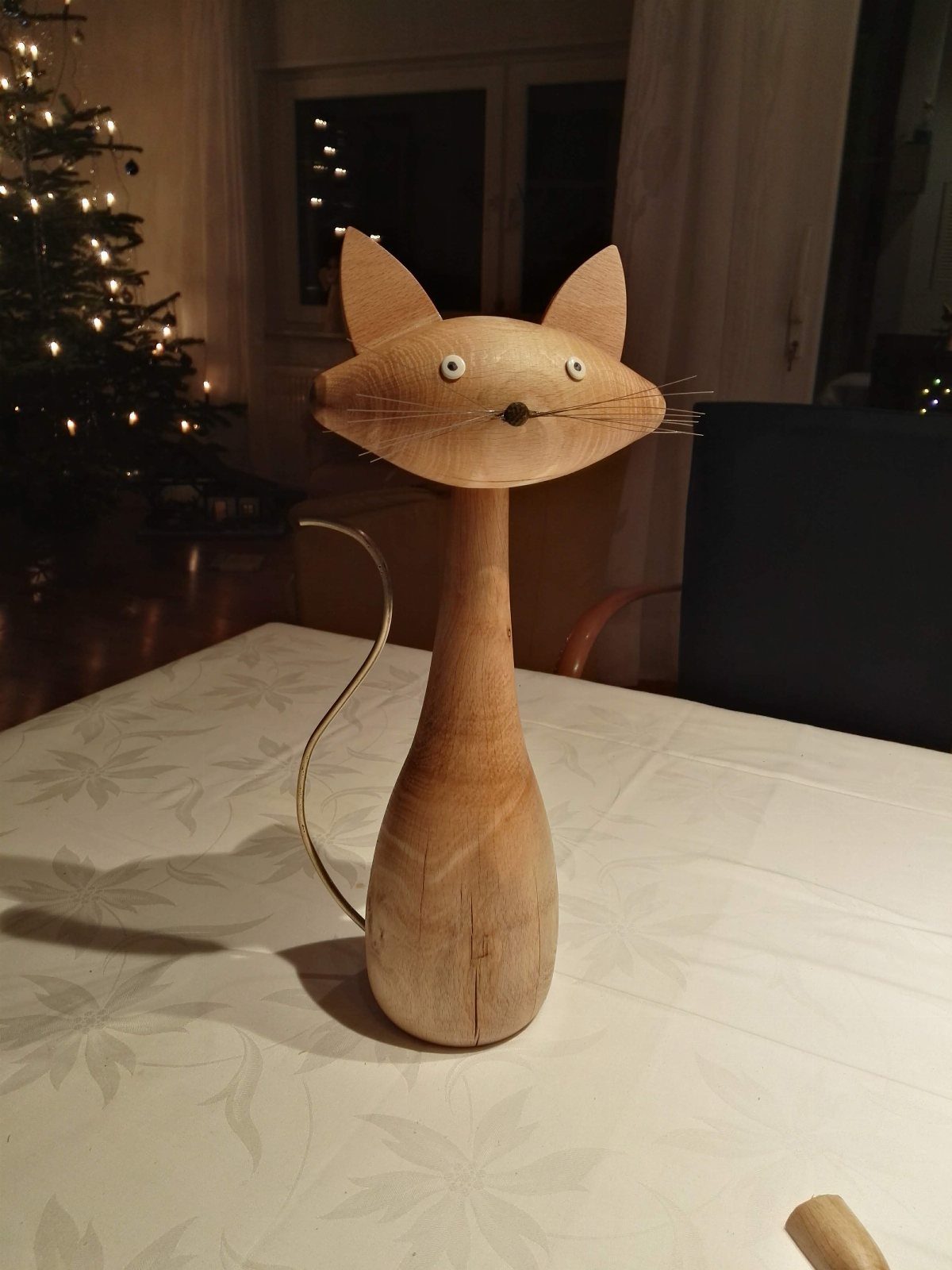 Wood Turned Cat Ideas: 5 Designs for the Lathe 2 Stylized wooden cat figurine with long neck and wire whiskers on a white table