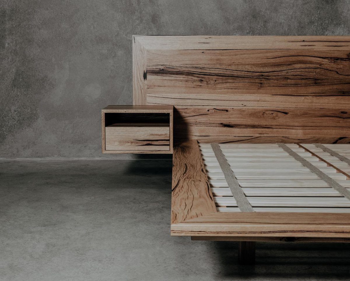 Wooden bed frame with a natural grain headboard and floating bedside table.