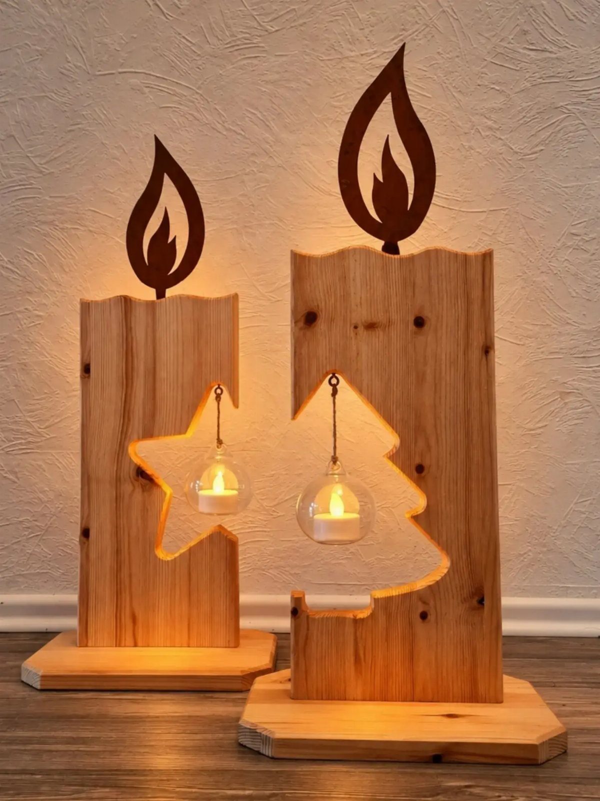 Wooden candle holders with flame cutouts and glass tea lights on pine bases.