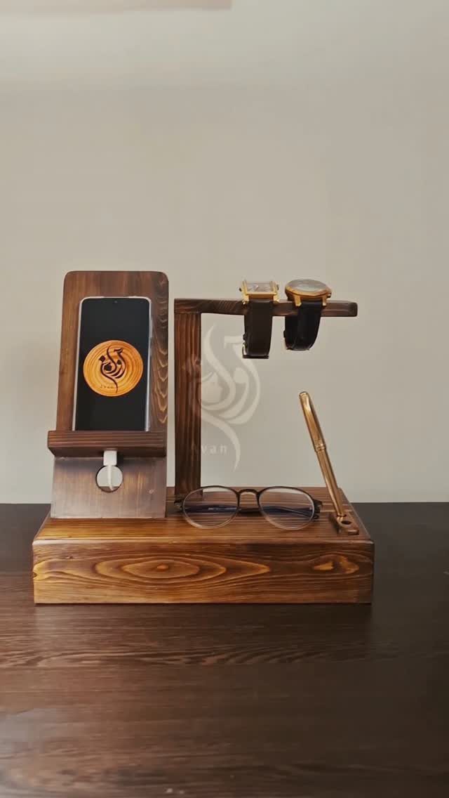 12 Woodworking Ideas to Make Money With Simple Builds 11 Wooden docking station holding a smartphone, two wristwatches, and a pair of eyeglasses.