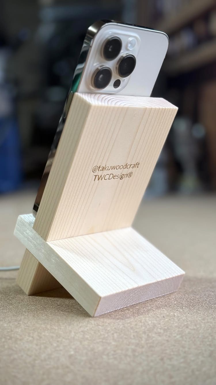 12 Woodworking Ideas to Make Money With Simple Builds 12 Wooden phone stand holding a silver smartphone on a neutral surface.
