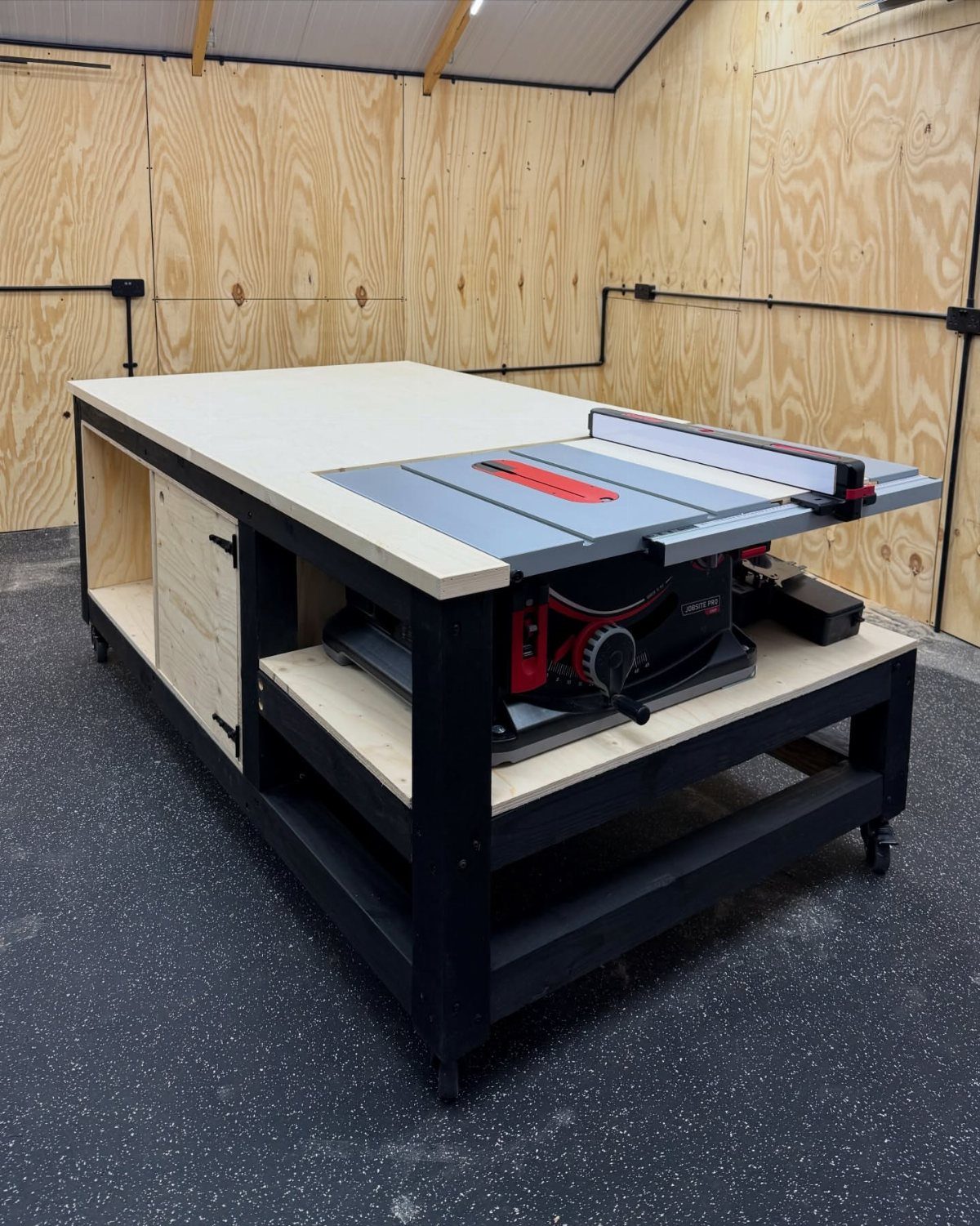 Woodworking Shop Furniture: 4 Ideas for Your Workspace 2 Woodworking workbench with integrated table saw in a plywood walled workshop