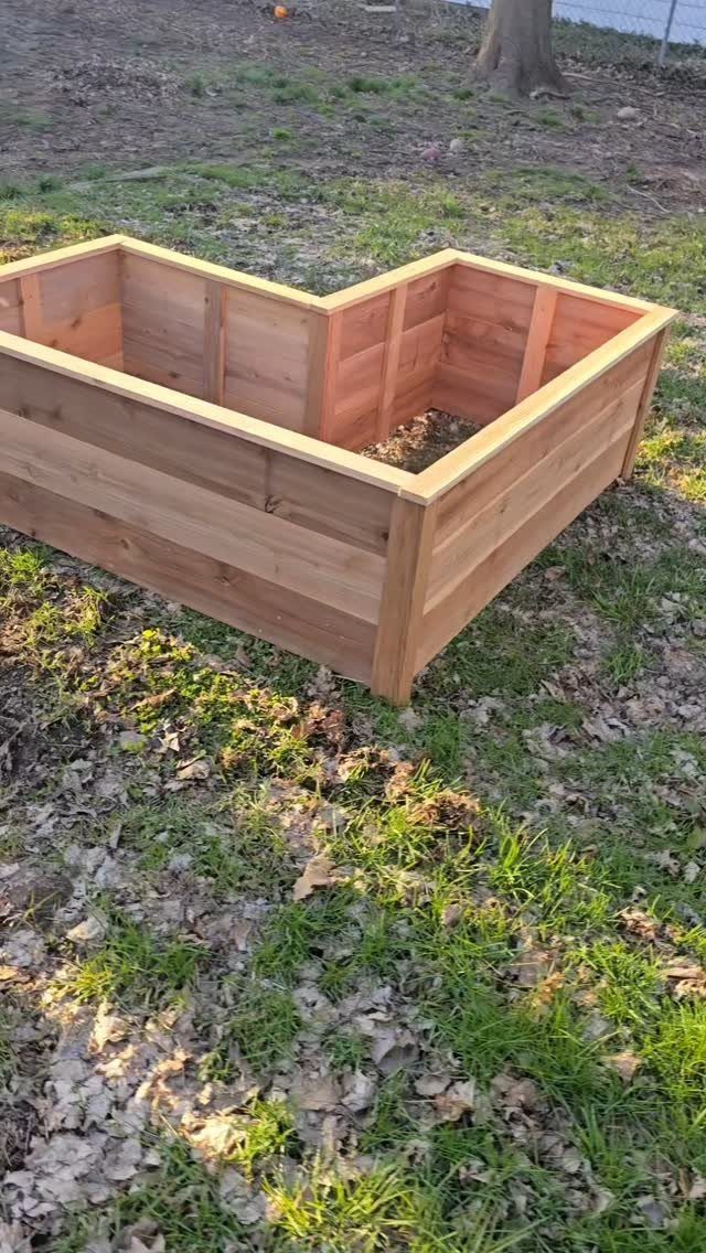 14 Woodworking Shop Projects for Every Skill Level 10 Wooden raised garden bed with a central divider sitting on a grassy lawn