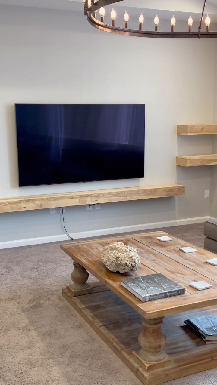 14 Woodworking Shop Projects for Every Skill Level 3 Wooden floating shelves mounted on a wall below a television in a living room