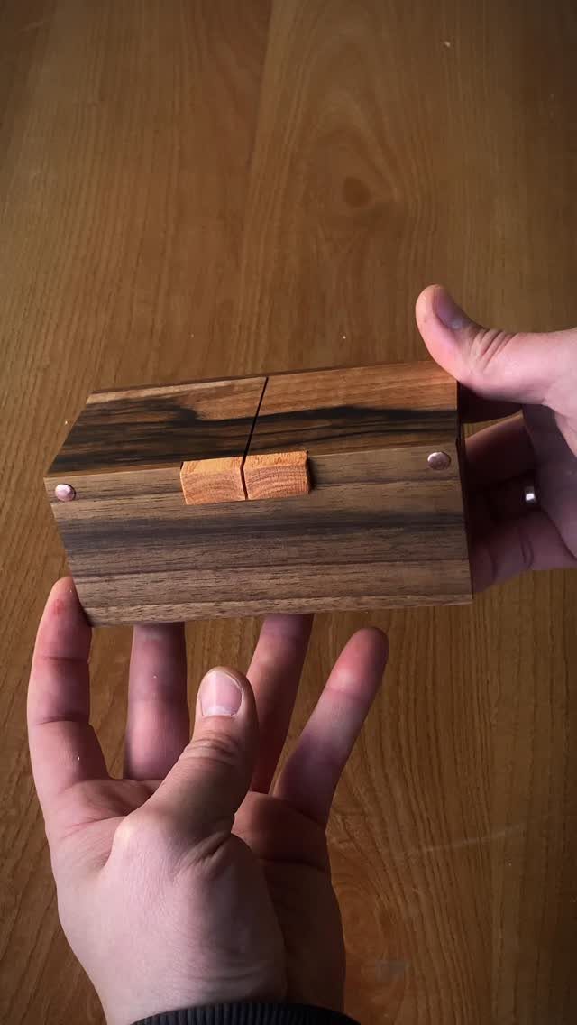 Woodworking Small Box Ideas: 5 Projects to Build 1 Small rectangular dark wood box with a light wood latch held by hands.