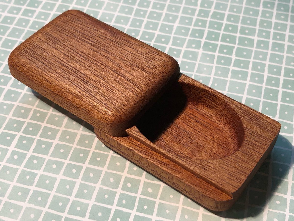Woodworking Small Box Ideas: 5 Projects to Build 3 Small brown wooden box with a sliding lid open on a grid background