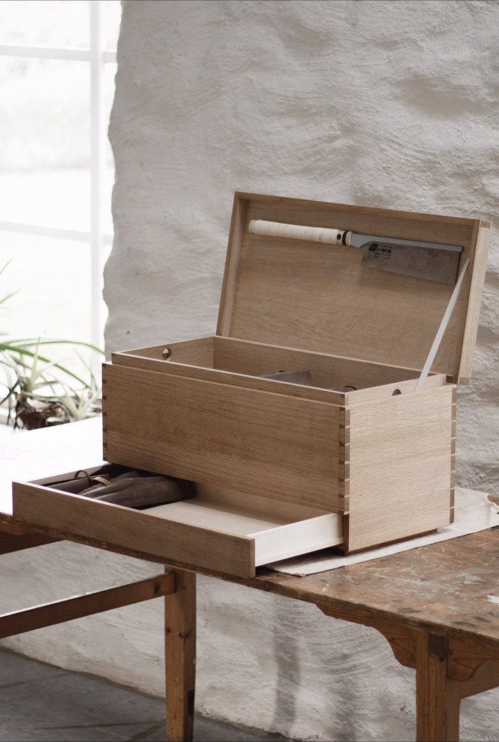 Woodworking Tool Cabinet Plans: 8 Storage Ideas 6 Wooden tool cabinet with open lid and drawer on a rustic workbench