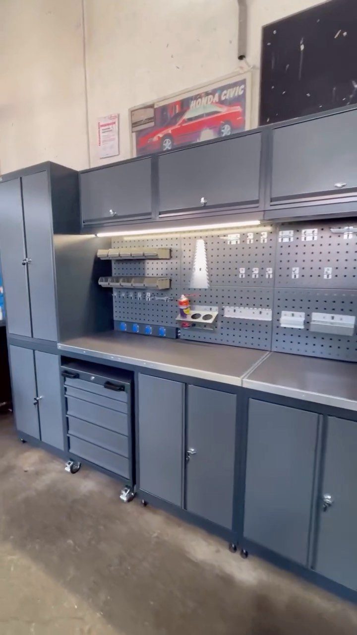 Workbench Tool Storage Ideas: 8 Setups for a Garage Shop 1 Grey modular workbench with upper cabinets, worktop, and pegboard tool storage in garage.