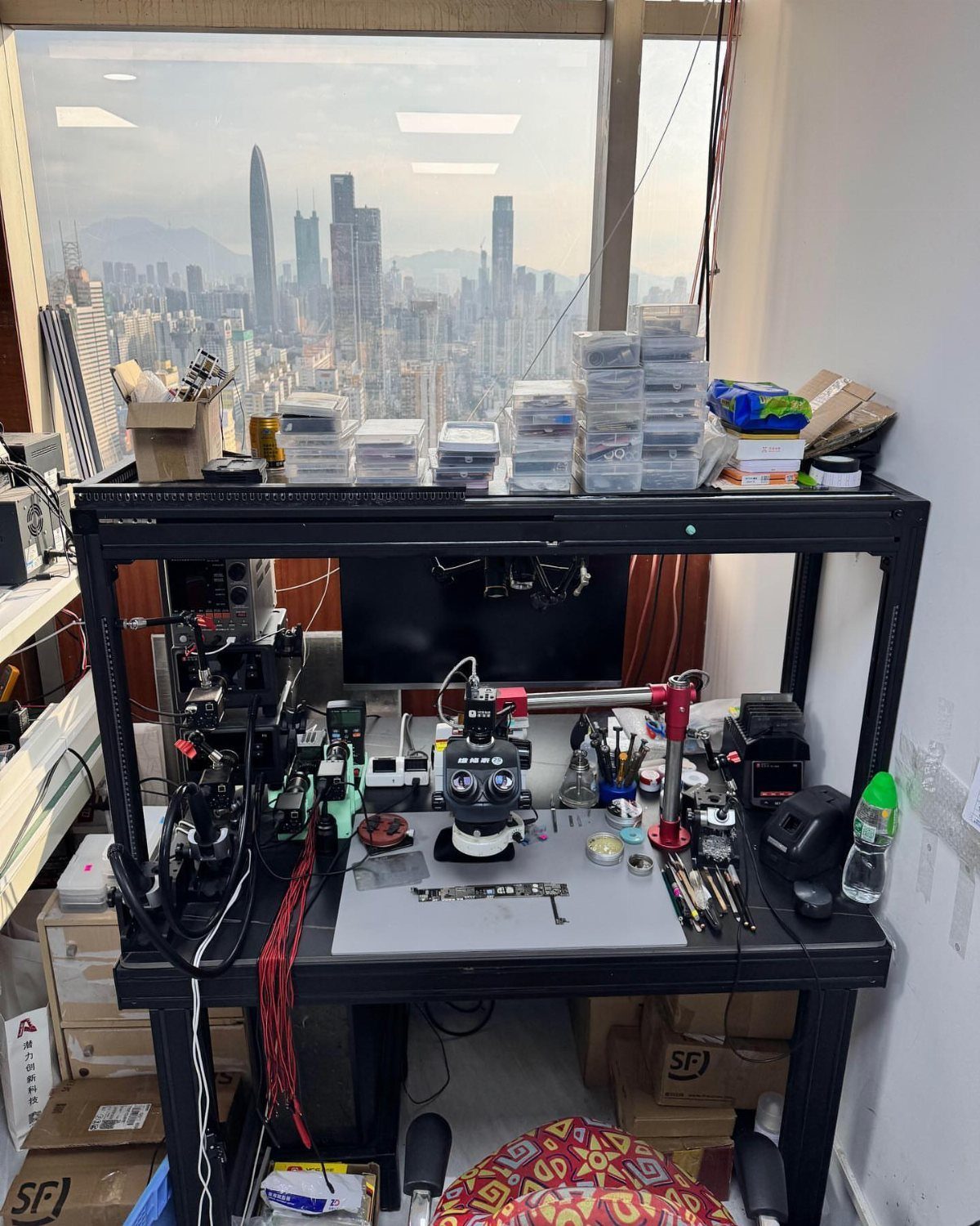 Workbench Tool Storage Ideas: 8 Setups for a Garage Shop 5 Black metal workstation with electronic tools and microscope overlooking a city skyline.