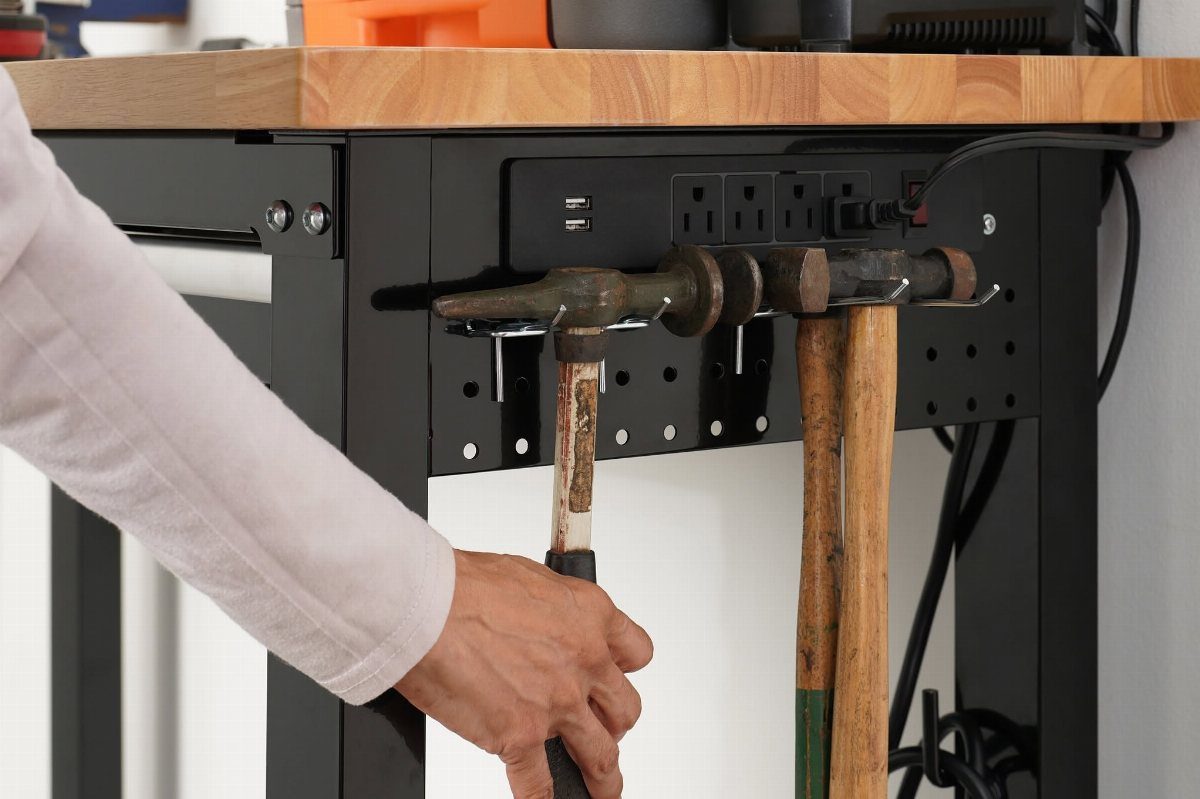 Workbench Tool Storage Ideas: 8 Setups for a Garage Shop 4 Integrated power strip with USB ports mounted on a black metal workbench frame.