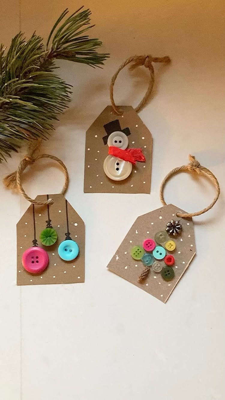 Brown cardboard gift tags decorated with colorful buttons and twine on a white surface.