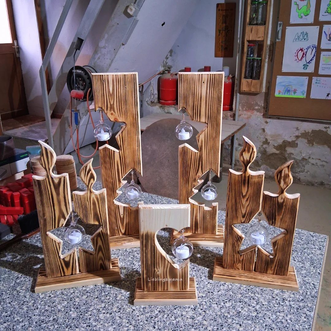 Wooden candle holders with natural grain and glass tea light inserts on a countertop.
